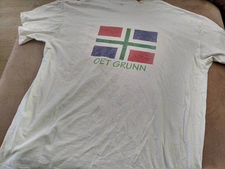 Camiseta blanca con un diseño estampado a color (imagen de archivo)
